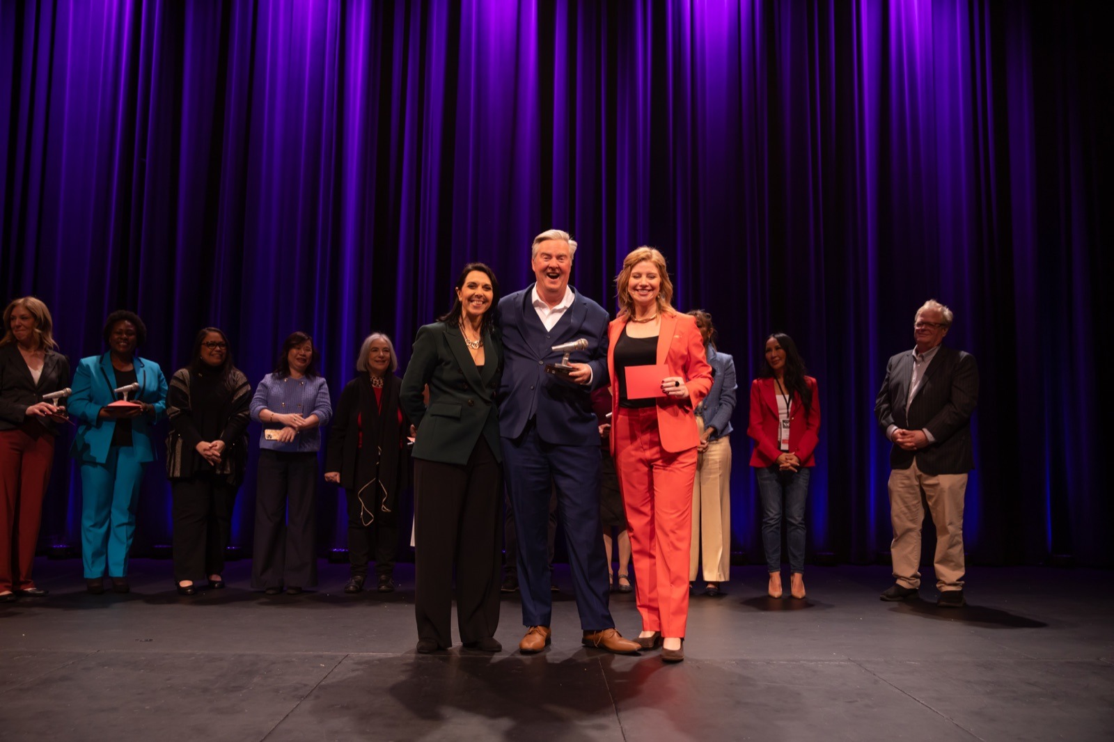 Bruce Scheer holding the NSA Northwest Speaker Showcase trophy with Anna Liotta and Sonja Price