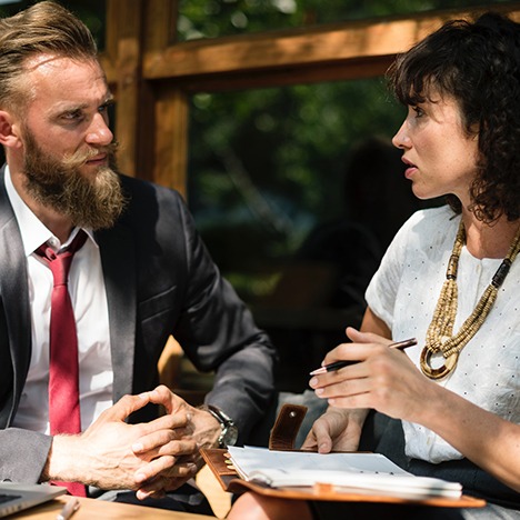 Two professional looking people having a discussion