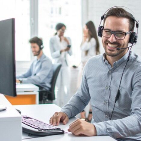 Person with a headset in an office smiling
