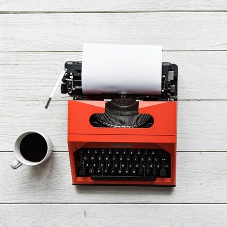 a typewriter and a cup of coffee